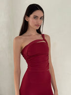 Woman wearing a red dress against a plain background